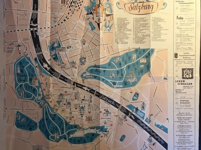 Complete vintage pictorial Salzburg plan with turquoise streets, salmon blocks, illustrated buildings, a numbered key and advertisements