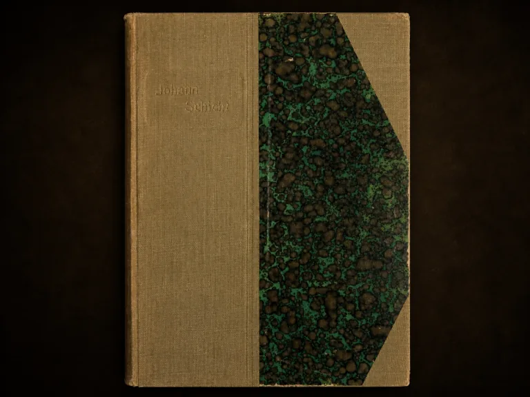 Front-on editorial view of the worn beige cloth and green-black marbled-paper cover of Johann Schicht: Sein Leben und Wirken