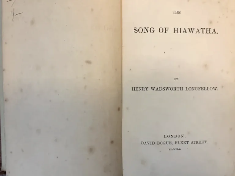 The title page of an 1855 London copy of The Song of Hiawatha by Henry Wadsworth Longfellow, presented on a dark RUSTY PECHA ground