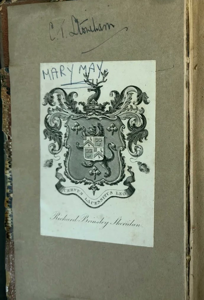 An engraved Richard Brinsley Sheridan bookplate on a brown pastedown, with Mary May in blue ink across it and a pencilled name above.