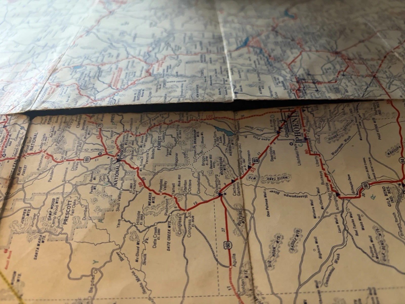 Close view of a long fold separation cutting through road-map detail near Prescott and Phoenix.