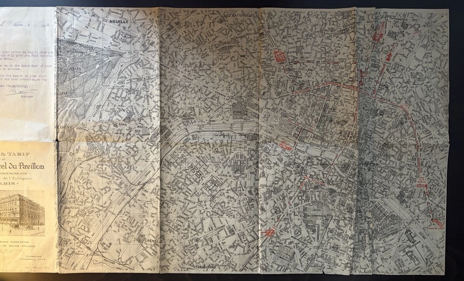 Large street plan of Paris printed in black with stations, main routes and selected landmarks highlighted in red, attached to the hotel cover and letter.