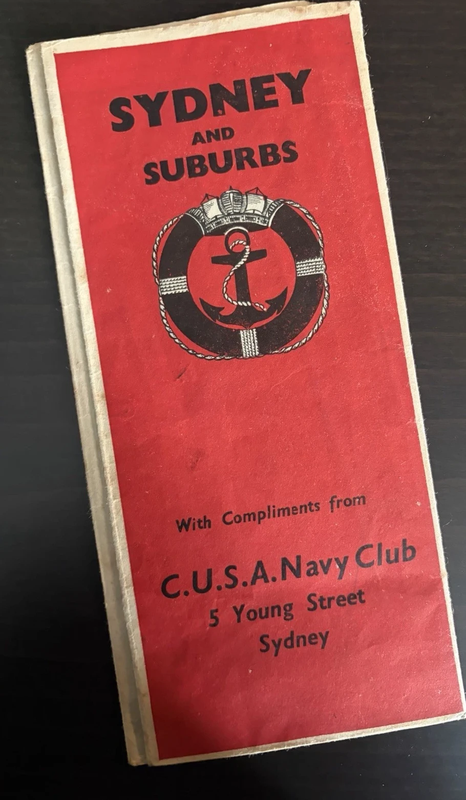 Tall red Sydney and Suburbs map cover with an anchor inside a lifebuoy and the address of the CUSA Navy Club at 5 Young Street, Sydney.