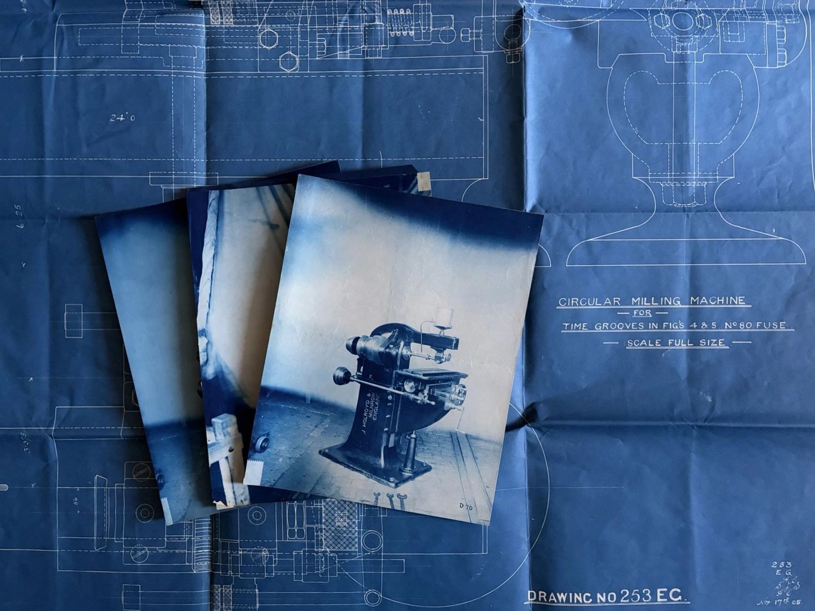 Circular milling machine blueprint with three black-and-white workshop photographs placed on top