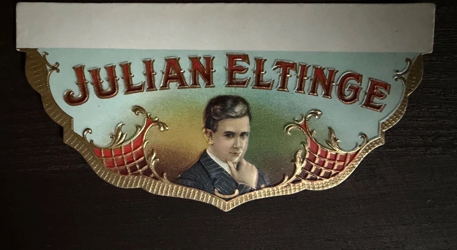 Julian Eltinge cigar-box label with a central portrait and ornate red and gold border