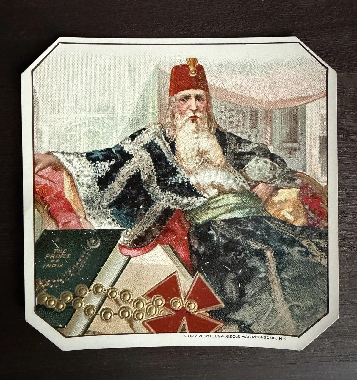 Prince of India cigar-box label with an illustrated figure in a red fez and embossed gold lettering